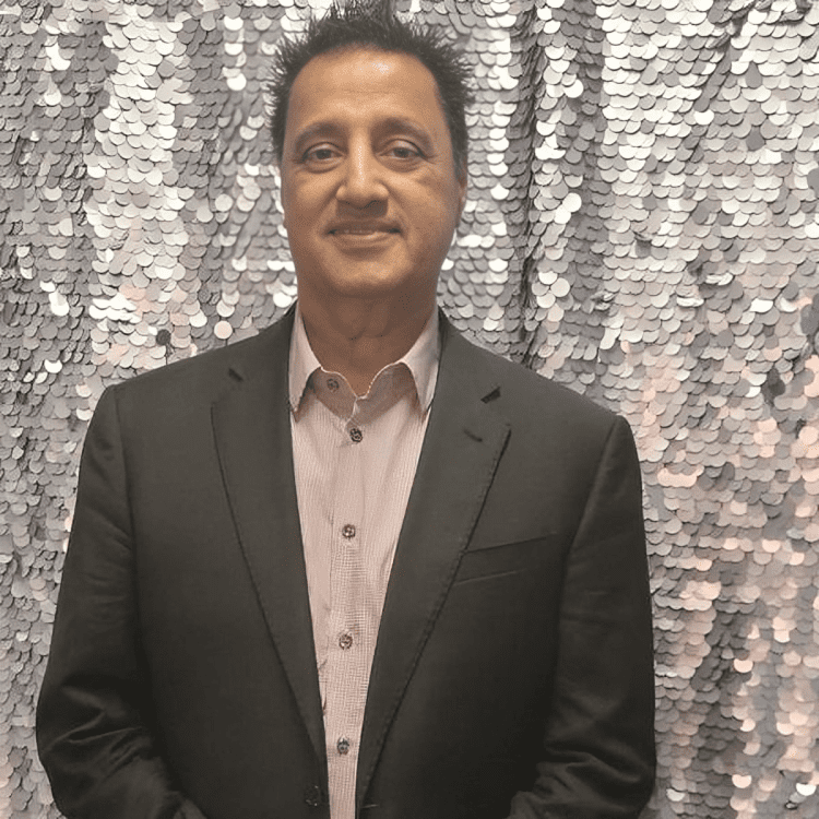 Man in suit with sequin background.