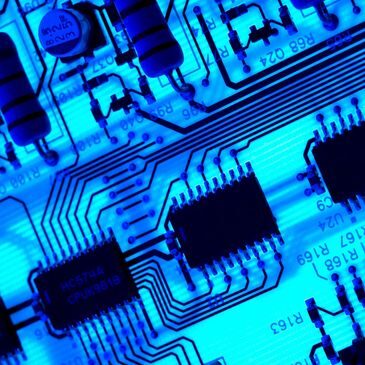 Blue circuit board with electronic components.